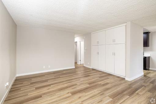 A room with wooden floors and white walls.
