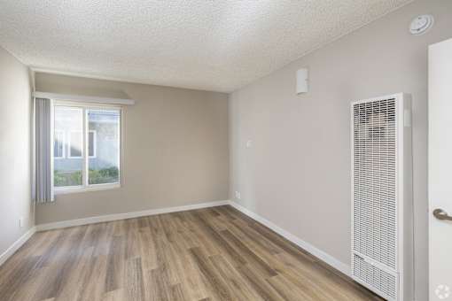 A room with a window and a door.