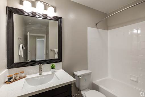 A bathroom with a sink, toilet, and bathtub.