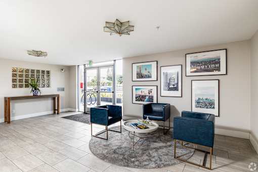 A living room with a blue chair and a coffee table.
