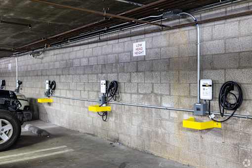 A wall of electrical outlets and a sign that says low head height.
