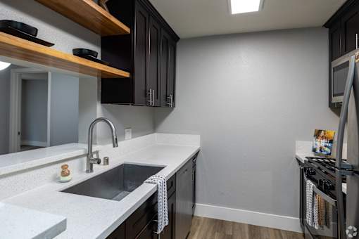 A kitchen with a sink and a dishwasher.