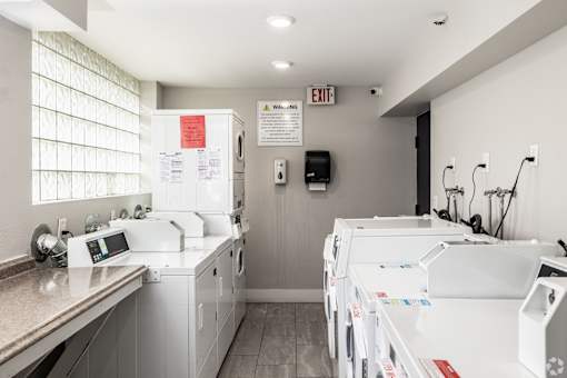 A laundry room with washers and dryers.