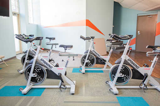 A room with four stationary bikes.