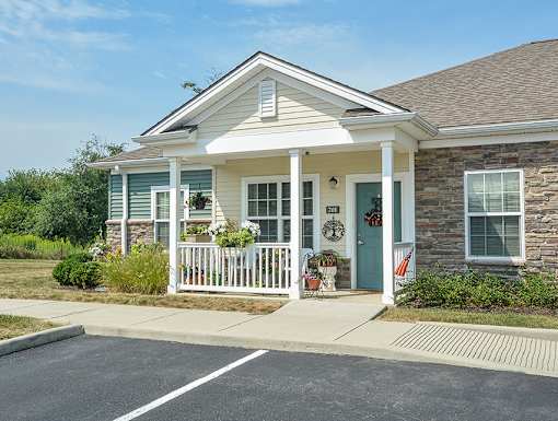 A house with a blue door and a white porch.
