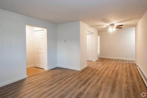 A room with wooden floors and white walls.