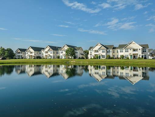 Reflection of houses in water at The Marlowe, Fort Wayne, Indiana