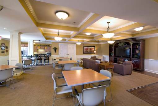A large room with a long table and chairs.