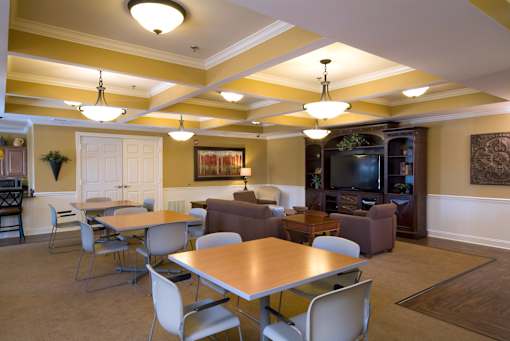 A living room with a dining table and chairs.