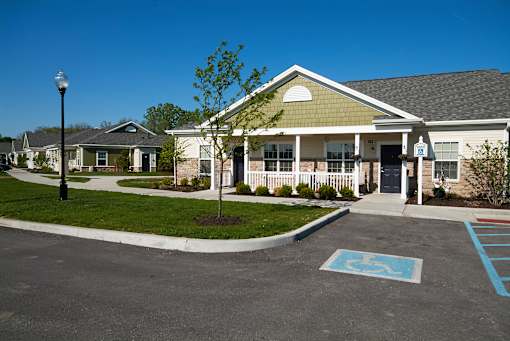A parking lot with a handicap parking space in front of a building.