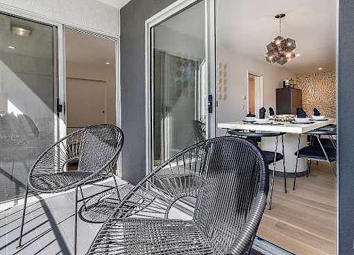 a patio with two chairs and a table at 8535 Colgate-Fully Furnished Apartments, Los Angeles, 90048
