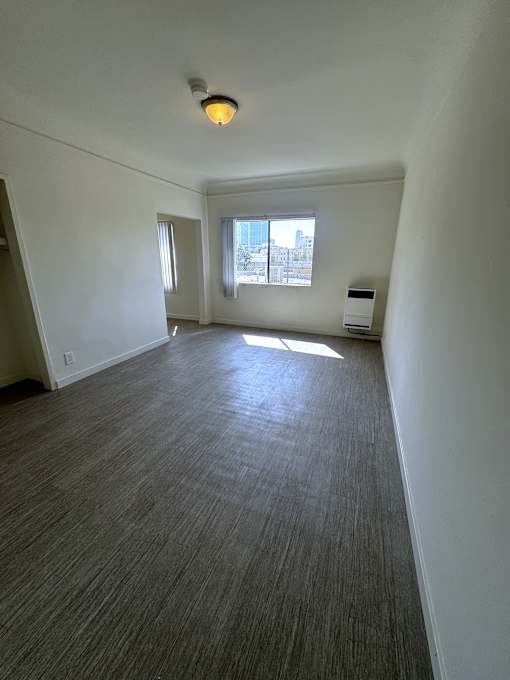 A room with a window and a light on the ceiling.