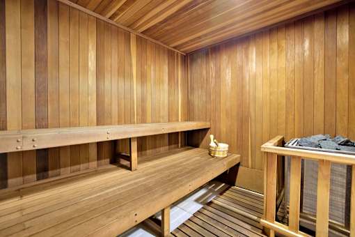 A wooden sauna with benches and a table with towels at Westwood Riviera Apartments, Apartments, Los Angeles, CA