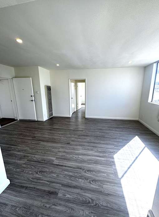 A room with a wooden floor and white walls.