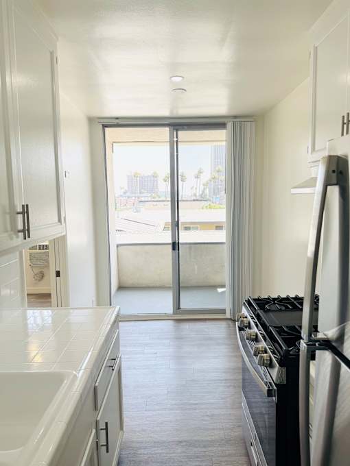 A kitchen with a stove and a sink.