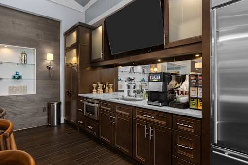 A modern kitchen with dark wood cabinets and stainless steel appliances. at Merion at Cross Keys Apartments, Apartments, Williamstown, NJ