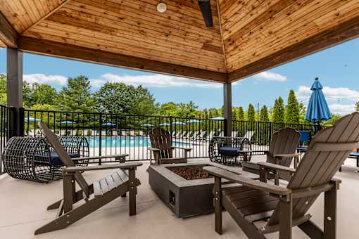 A wooden deck with chairs and a table.