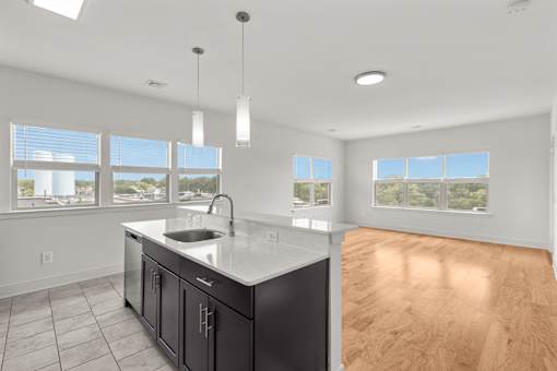 A kitchen with a sink and a window.