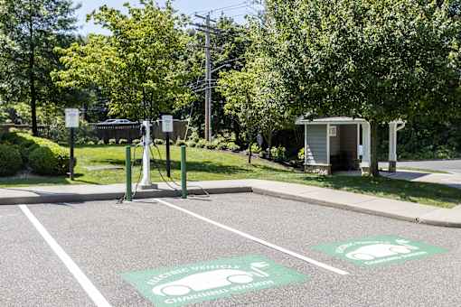 A parking lot with two electric vehicle charging stations.