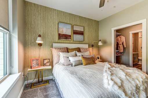 A bedroom with a large bed and a window.
