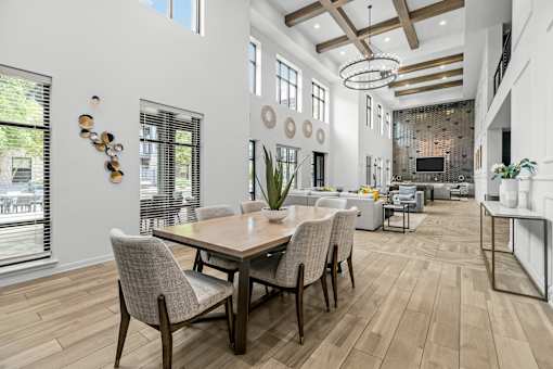 A dining room with a wooden table and chairs.