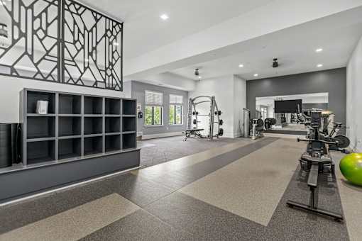 A gym with a variety of equipment including a green exercise ball.