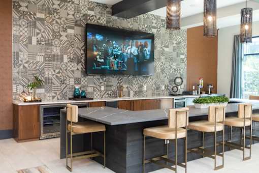 A modern kitchen with a large central island and a patterned backsplash.