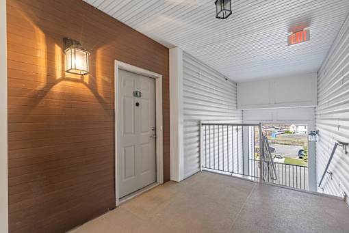 A white door is open to a balcony with a metal railing. at Pennsauken Golf Course Villas, PENNSAUKEN, NJ, 08109