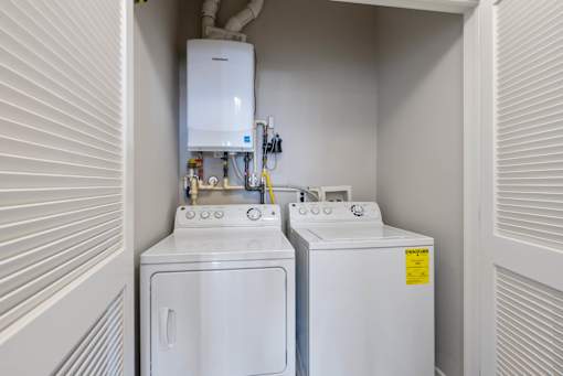 A small laundry room with a washer and dryer.