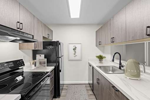 Modern galley kitchen with stainless steel appliances at The Northway at Clifton Park Apartments, Clifton Park, NY