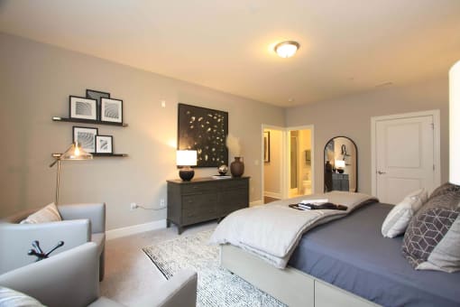 A bedroom with a bed and a dresser  at Barclay Glen Apartments, New Jersey, 08094