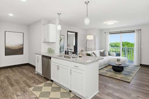 A modern kitchen with white cabinets and a large island.