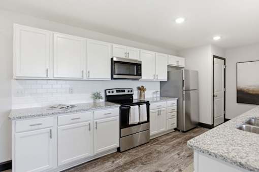 Modern luxury white kitchen with stainless appliances