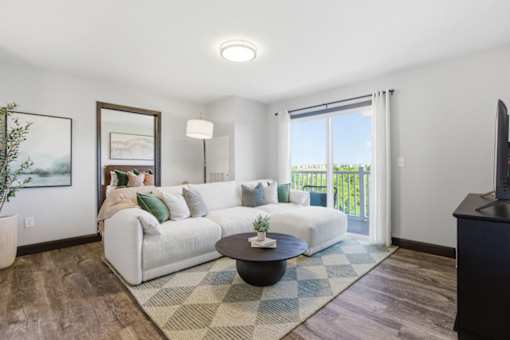 A living room with a white couch and a coffee table.