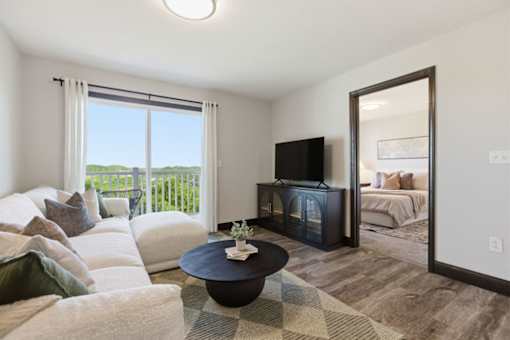 A living room with a white couch and a black coffee table.
