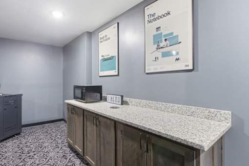 A room with a counter and a poster on the wall.