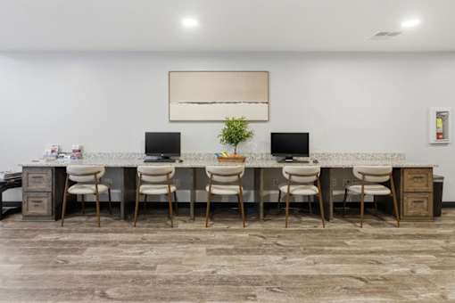 A room with a long table and chairs.