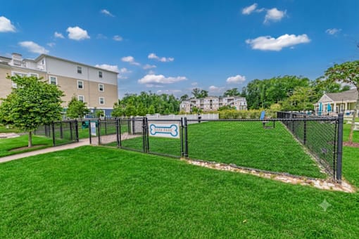 A dog park with a sign that says "Barking Dog Park".