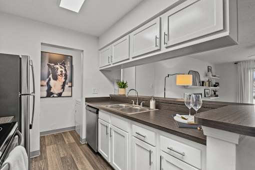 A modern kitchen with white cabinets and a wooden countertop. at Eagle Ridge Apartments, Monroeville, 15146