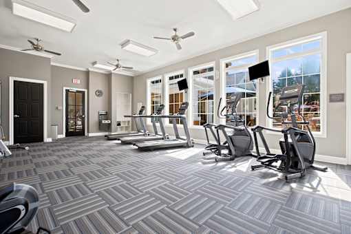 A gym with treadmills and exercise machines.