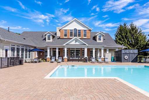 A large house with a pool in the backyard.