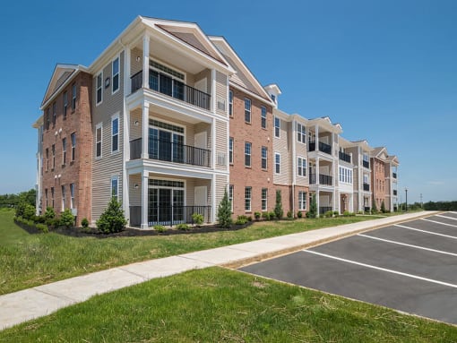 Exterior of 3-story apartment building with pathway in front  at Barclay Glen Apartments, Williamstown, NJ, 08094