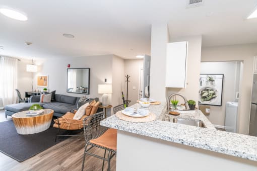an open living room with a kitchen and a couch at Merion Milford Apartment Homes, Milford, 06460