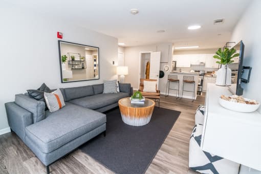 a living room with a couch and a table at Merion Milford Apartment Homes, Milford