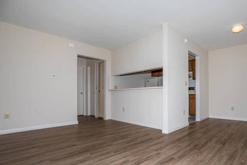 A room with wooden floors and white walls.
