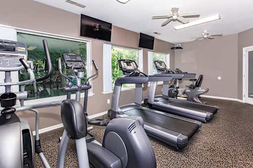 A spacious gym with treadmills, elliptical machines, and exercise bikes. at North Pointe Apartments, Clifton Park, NY