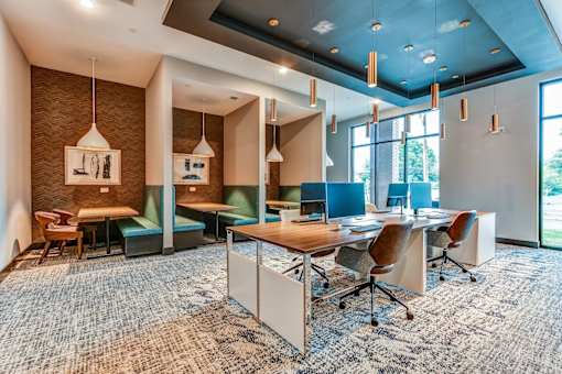 A conference room with a long table and chairs.