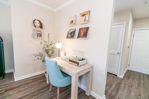 a bedroom with a desk and a chair and a door at The Ledges Apartment Homes, Groton, CT, 06340