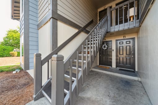 a stairway leading up to the front door of a house