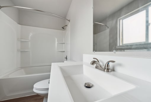 a bathroom with a toilet sink and bathtub